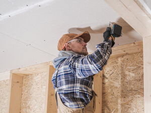 drywall installation during ceiling and wall reconstruction for storm damaged house in Rocky Mount NC