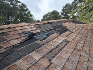 roof with missing shingles due to high winds from a powerful storm in Rocky Mount NC
